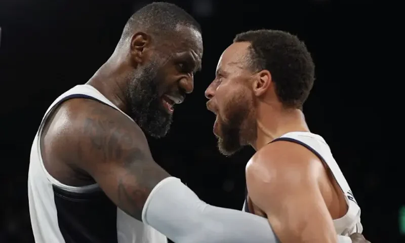 Lebron James of United States and Stephen Curry of United States celebrate after the match. REUTERS/Brian Snyder