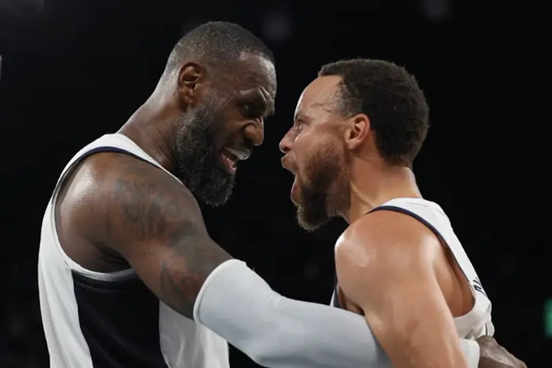 Lebron James of United States and Stephen Curry of United States celebrate after the match. REUTERS/Brian Snyder