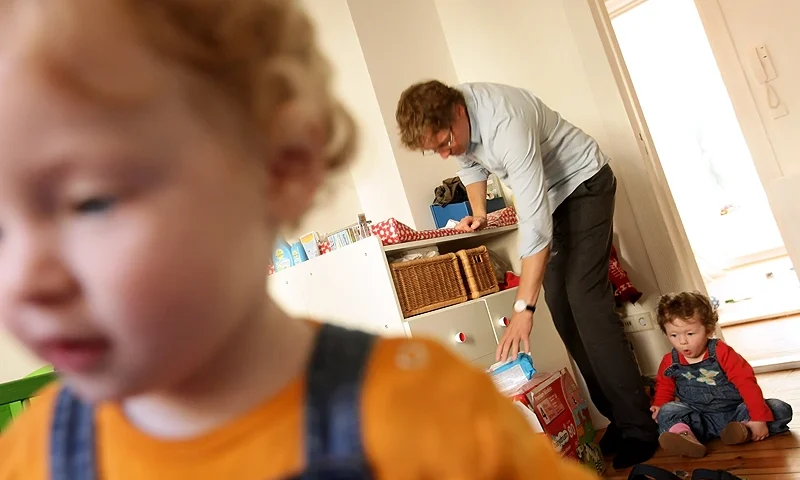 BERLIN - AUGUST 31: Oliver H., 42, a married federal employee on 6-month paternity leave, prepares to change the diapers of his twin 14-month-old daughters Lotte (R) and Alma at his home on August 31, 2010 in Berlin, Germany. Under German law married couples may take 14 months parent leave, to be divided between the two spouses, during which an individual receives two thirds of his or her normal income from the state, up to EUR 1,800 a month. In order to encourage more fathers to take paternity leave, German Family Minister Kristina Schroeder is seeking to lengthen parent leave from the current 14 months to 16 months, though German Finance Minister Wolfgang Schaeuble sees the measure as too expensive. (Photo by Sean Gallup/Getty Images)