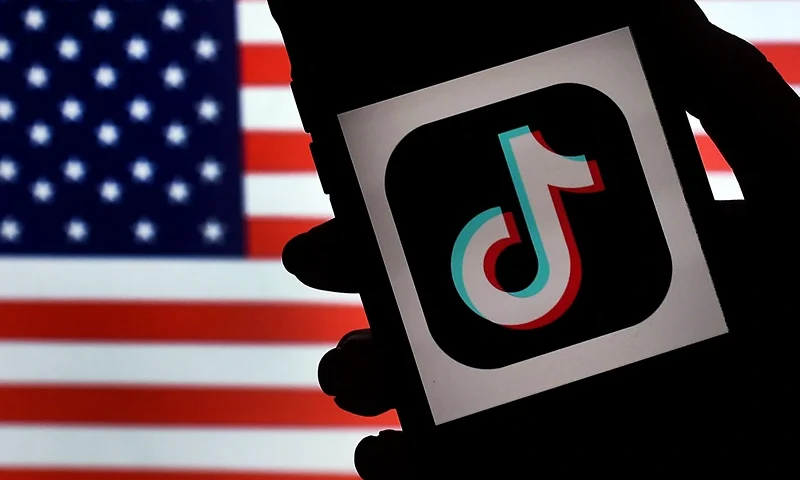 In this photo illustration, the social media application logo, TikTok is displayed on the screen of an iPhone on an American flag background on August 3, 2020 in Arlington, Virginia. - The US Senate voted on August 6, 2020, to bar TikTok from being downloaded onto US government employees' telephones, intensifying US scrutiny of the popular Chinese-owned video app. The bill passed by the Republican controlled Senate now goes to the House of Representatives, led by Democrats. (Photo by Olivier DOULIERY / AFP) (Photo by OLIVIER DOULIERY/AFP via Getty Images)
