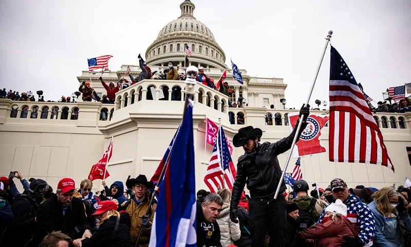 WASHINGTON, DC - JANUARY 06: Pro-Trump supporters storm the U.S. Capitol following a rally with President Donald Trump on January 6, 2021 in Washington, DC. Trump supporters gathered in the nation's capital today to protest the ratification of President-elect Joe Biden's Electoral College victory over President Trump in the 2020 election. (Photo by Samuel Corum/Getty Images)