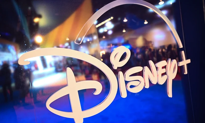 Fans are reflected in Disney+ logo during the Walt Disney D23 Expo in Anaheim, California on September 9, 2022. (Photo by Patrick T. FALLON / AFP) (Photo by PATRICK T. FALLON/AFP via Getty Images)