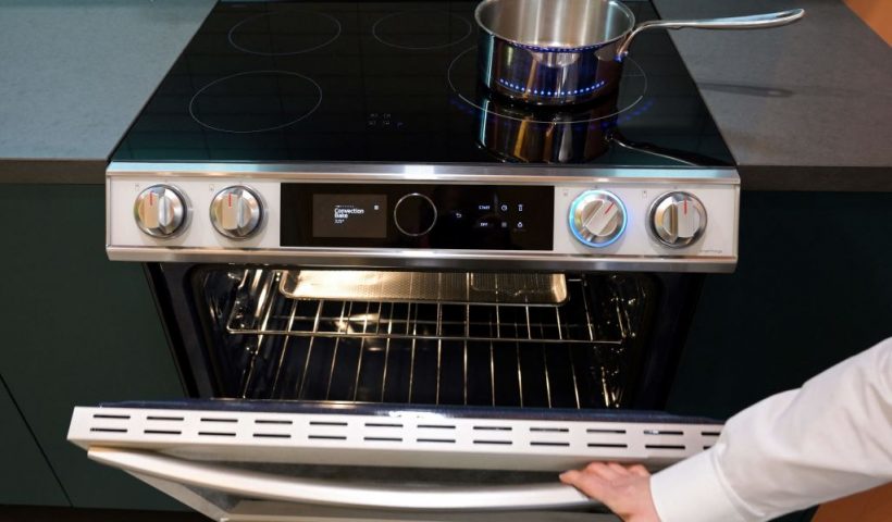 A product expert demonstrates the oven beneath an electric induction stove cooktop during a preview of Samsung Electronics Co.s Bespoke Home appliances and SmartThings home technologies ahead of the Consumer Electronics Show (CES) in Las Vegas, Nevada, on January 3, 2023. - CES takes place from January 5-8, 2023. (Photo by Patrick T. Fallon / AFP) (Photo by PATRICK T. FALLON/AFP via Getty Images)