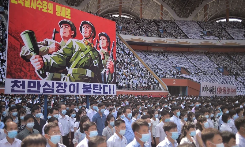 In this photo taken on June 25, 2023, a banner that reads "Tens of millions of people pledge to defy death for defending country!" is seen as residents of Pyongyang attend a mass rally to mark the "day of struggle against US imperialism", on the 73rd anniversary of the three-year Korean War, which began on June 25, 1950, at the Mayday Stadium in Pyongyang. (Photo by KIM Won Jin / AFP) (Photo by KIM WON JIN/AFP via Getty Images)