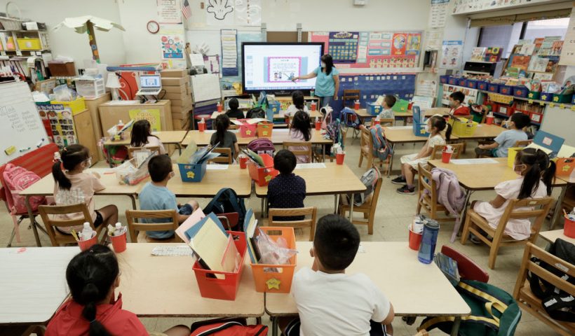 NEW YORK, NEW YORK - JULY 22: Melissa Moy, a teacher at Yung Wing School P.S. 124, goes over a lesson on a monitor with in-person Summer program students on July 22, 2021 in New York City. Positive COVID-19 cases in some New York City public schools have resulted in classroom quarantines. (Photo by Michael Loccisano/Getty Images)