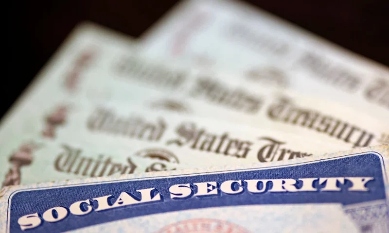 WASHINGTON, DC - OCTOBER 14: In this photo illustration, a Social Security card sits alongside checks from the U.S. Treasury on October 14, 2021 in Washington, DC. The Social Security Administration announced recipients will receive an annual cost of living adjustment of 5.9%, the largest increase since 1982. The larger increase is aimed at helping to offset rising inflation. (Photo illustration by Kevin Dietsch/Getty Images)