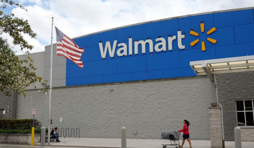 MIAMI, FLORIDA - JANUARY 24: A customer leaves a Walmart store on January 24, 2023 in Miami, Florida. Walmart announced that it is raising its minimum wage for store employees in early March, store employees will make between $14 and $19 an hour. They currently earn between $12 and $18 an hour. (Photo by Joe Raedle/Getty Images)