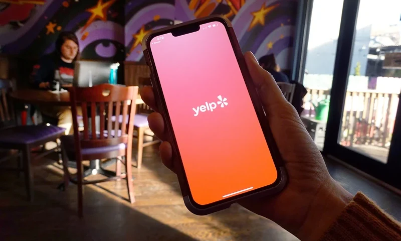 A Yelp splash page is displayed on a cell phone on November 14, 2023 in Chicago, Illinois. Yelp recently reported third quarter profit which was up more than 500 percent compared with a year earlier. (Photo Illustration by Scott Olson/Getty Images)