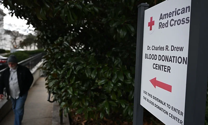 A man leaves a blood donation center at the American Red Cross national headquarters is seen in Washington, DC on February 2, 2024. (Photo by ANDREW CABALLERO-REYNOLDS / AFP) (Photo by ANDREW CABALLERO-REYNOLDS/AFP via Getty Images)