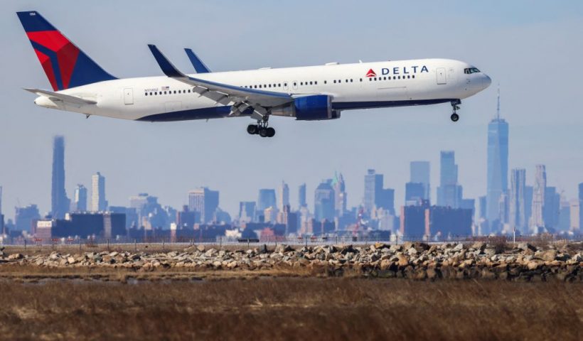 A Boeing 767 passenger aircraft of Delta airlines arrives from Dublin at JFK International Airport in New York as the Manhattan skyline looms in the background on February 7, 2024. (Photo by Charly TRIBALLEAU / AFP) (Photo by CHARLY TRIBALLEAU/AFP via Getty Images)