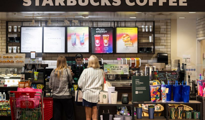 Customers order at a Starbucks in Manhattan Beach, California, on July 19, 2024. Starbucks is among the businesses impacted as Airlines, banks, TV channels and other businesses were disrupted worldwide on July 19 following a major computer systems outage linked to an update on an antivirus program. (Photo by ETIENNE LAURENT / AFP) (Photo by ETIENNE LAURENT/AFP via Getty Images)