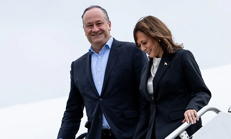 US Vice President Kamala Harris and second gentleman Douglas Emhoff descend from Air Force Two at Delaware National Air Guard base in New Castle, Delaware, on July 22, 2024. Harris is set to meet campaign staff in Wilmington. Harris on Monday won the crucial backing of Democratic heavyweight Nancy Pelosi to lead the party against Donald Trump in November after Joe Biden's stunning exit from the 2024 race. As the endorsements stacked up, the 59-year-old Harris made her first public appearance since Biden's announcement in a ceremony at the White House where she warmly praised the outgoing president's "unmatched" achievements. (Photo by Erin SCHAFF / POOL / AFP) (Photo by ERIN SCHAFF/POOL/AFP via Getty Images)