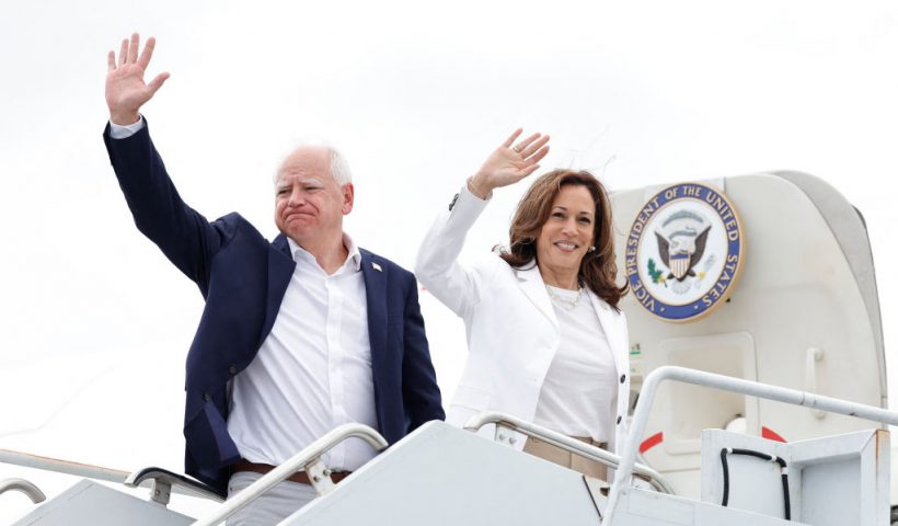 TOPSHOT - US Vice President and 2024 Democratic presidential candidate Kamala Harris and her running mate Minnesota Governor Tim Walz wave as they board Air Force Two, departing Chippewa Valley Regional Airport in Eau Claire, Wisconsinon, August 7, 2024. (Photo by KAMIL KRZACZYNSKI / AFP) (Photo by KAMIL KRZACZYNSKI/AFP via Getty Images)