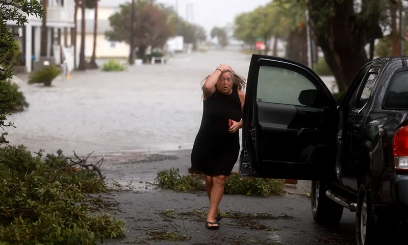 CEDAR KEY, FLORIDA - AUGUST 05: Christy Hatcher checks on her neighborhood as high winds, rain and storm surge from Hurricane Debby inundate the area on August 05, 2024, in Cedar Key, Florida. Hurricane Debby brings rain storms and high winds along Florida’s Big Bend area. (Photo by Joe Raedle/Getty Images)