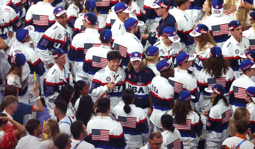 PARIS, FRANCE - AUGUST 11: Flagbearer Katie Ledecky poses with athletes from Team United States during the Closing Ceremony of the Olympic Games Paris 2024 at Stade de France on August 11, 2024 in Paris, France. (Photo by Michael Reaves/Getty Images)