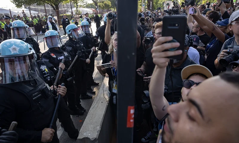 Police confront pro-Palestinian activists after they breached the security fence during a demonstration outside the venue of the Democratic National Convention (DNC) in Chicago, Illinois, on August 19, 2024. Vice President Kamala Harris will formally accept the party's nomination for president at the DNC which runs from August 19-22 in Chicago. (Photo by CHRISTIAN MONTERROSA / AFP) (Photo by CHRISTIAN MONTERROSA/AFP via Getty Images)