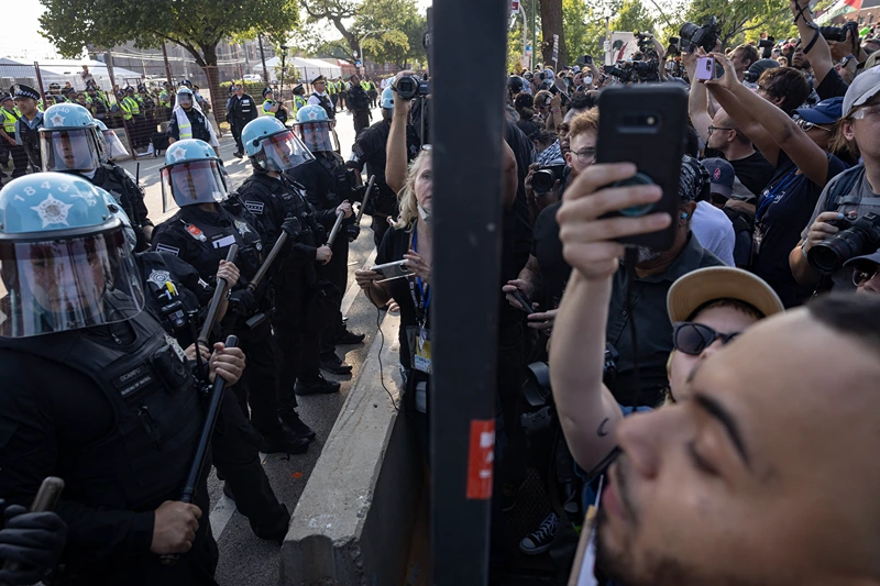 Police confront pro-Palestinian activists after they breached the security fence during a demonstration outside the venue of the Democratic National Convention (DNC) in Chicago, Illinois, on August 19, 2024. Vice President Kamala Harris will formally accept the party's nomination for president at the DNC which runs from August 19-22 in Chicago. (Photo by CHRISTIAN MONTERROSA / AFP) (Photo by CHRISTIAN MONTERROSA/AFP via Getty Images)