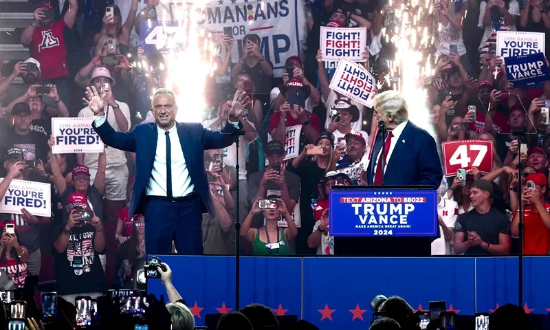 TOPSHOT - Former US President and Republican presidential candidate Donald Trump (R) welcomes onstage Independent presidential candidate Robert F. Kennedy Jr. (L) during a campaign rally at the Desert Diamond Arena in Glendale, Arizona, August 23, 2024. Robert F. Kennedy Jr, scion of America's storied political clan, suspended his long shot presidential bid on August 23, 2024 and endorsed Donald Trump, injecting a new dose of uncertainty into the White House race. (Photo by Olivier TOURON / AFP) (Photo by OLIVIER TOURON/AFP via Getty Images)
