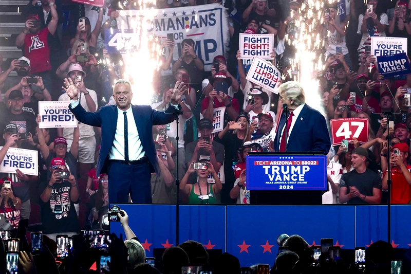 TOPSHOT - Former US President and Republican presidential candidate Donald Trump (R) welcomes onstage Independent presidential candidate Robert F. Kennedy Jr. (L) during a campaign rally at the Desert Diamond Arena in Glendale, Arizona, August 23, 2024. Robert F. Kennedy Jr, scion of America's storied political clan, suspended his long shot presidential bid on August 23, 2024 and endorsed Donald Trump, injecting a new dose of uncertainty into the White House race. (Photo by Olivier TOURON / AFP) (Photo by OLIVIER TOURON/AFP via Getty Images)