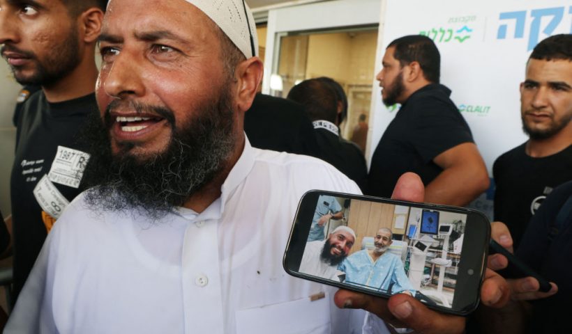 The brother of freed Israeli hostage Kaid Alkadi shows a picture with him on his phone after meeting him at Soroka Medical Center in Beersheva in southern Israel on August 27, 2024. The Israeli military said its forces rescued an Israeli hostage in southern Gaza on August 27 after a "complex operation" as the war between Israel and Hamas, now in its 11th month, showed no signs of abating. (Photo by Menahem KAHANA / AFP) (Photo by MENAHEM KAHANA/AFP via Getty Images)