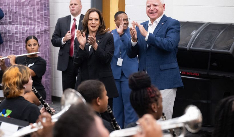 Democratic presidential candidate US Vice President Kamala Harris and her running mate, Governor Tim Walz,enjoy music by members of the marching band at Liberty County High School in Hinesville, Georgia, August 28, 2024, as they travel across Georgia for a 2-day campaign bus tour. (Photo by SAUL LOEB / AFP) (Photo by SAUL LOEB/AFP via Getty Images)