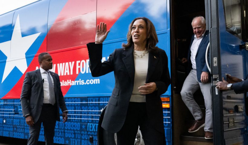 TOPSHOT - Democratic presidential candidate US Vice President Kamala Harris and her running mate, Minnesota Governor Tim Walz, disembark from their campaign bus in Savannah, Georgia, August 28, 2024, as they travel across Georgia for a 2-day campaign bus tour. (Photo by SAUL LOEB / AFP) (Photo by SAUL LOEB/AFP via Getty Images)