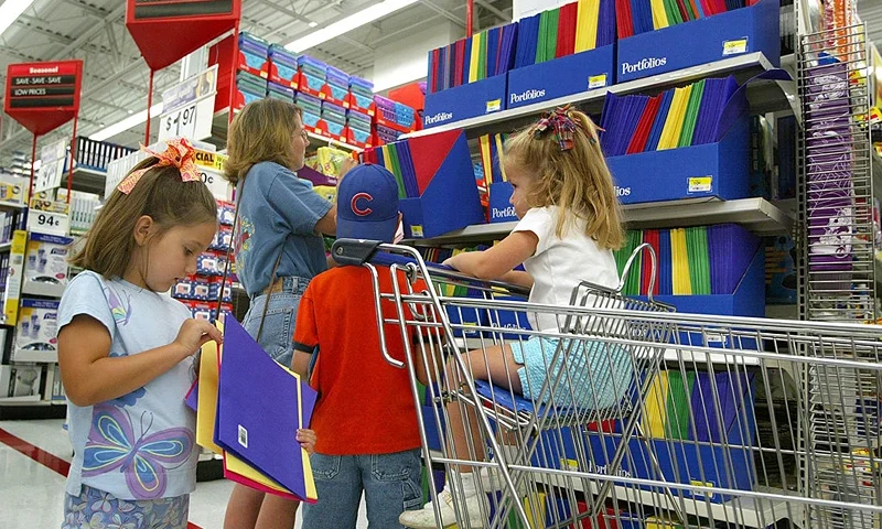 ROLLING MEADOWS, IL - JULY 26: Shoppers peruse notebooks and other back-to-school items in a Wal-Mart store July 28, 2003 in Rolling Meadows, Illinois. Wal-Mart said that sales in the month of July at its U.S. stores that were open at least one year could top expectations. Warm weather has helped turnaround slower retail sales following the cooler weather of May and June. (Photo by Tim Boyle/Getty Images)