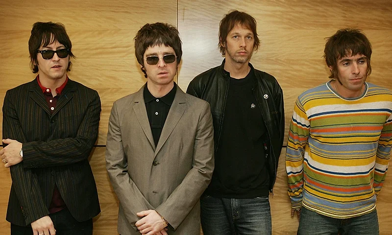 Hong Kong, CHINA: From L-R Gem, Noel Gallagher, Andy Bell and Liam Gallagher, members of the British rock band "Oasis" hold a photocall in Hong Kong 25 February 2006. The Band are to hold a concert 25 February. AFP PHOTO/MIKE CLARKE (Photo by MIKE CLARKE/AFP via Getty Images)
