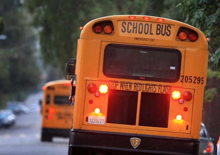 PASADENA, CA - OCTOBER 10: School buses drive down teh road to pick up children before classes begin on October 10, 2008 in Pasadena, California. California State Treasurer Bill Lockyer has warned that California cash revenues will run out by the end of the month. If that happens, 5,000 California cities, counties, and school districts will face job layoffs and payments for law enforcement agencies, nursing homes, teachers, and other services and government entities could be suspended. A worldwide credit crunch threatens to derail state plans for a routine 7 billion dollar loan to even out the tax flow into the state treasury. Just two weeks after state lawmakers came to agreement, after months of haggling on a record-overdue state budget, California Gov. Arnold Schwarzenegger is warning of future cuts to the state budget to deal with skyrocketing financial problems. A frozen credit market and revenues for the first quarter of the fiscal year that fell more than a billion dollars short of previous projections are causing the governor and state legislative leaders scrabbling to deal with a new budget mess. (Photo by David McNew/Getty Images)