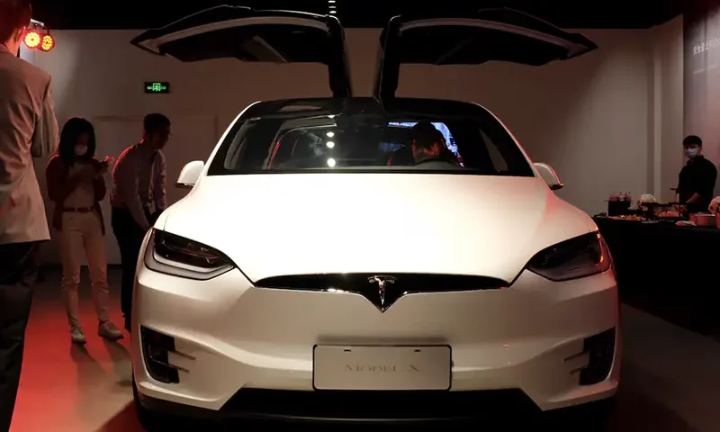 People check a Tesla Model X sport utility vehicle at a new Tesla showroom in Shanghai, China May 8, 2020. REUTERS/Yilei Sun