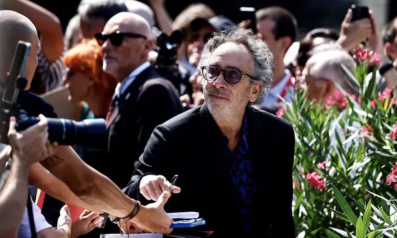 Director Tim Burton signs autographs, on the day of a photocall for the film "Beetlejuice Beetlejuice", which is screening out of competition, at the 81st Venice Film Festival, Venice, Italy, August 28, 2024. REUTERS/Yara Nardi