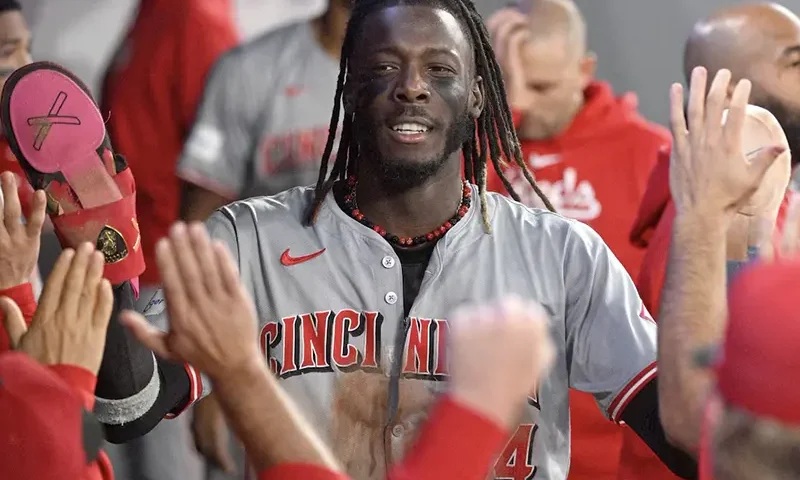 Cincinnati Reds shortstop Elly De La Cruz (44) celebrates in the dugout with team mates after scoring against the Toronto Blue Jays and achieving his 60th stolen base of the season in the fifth inning at Rogers Centre. Mandatory Credit: Dan Hamilton-USA TODAY Sports