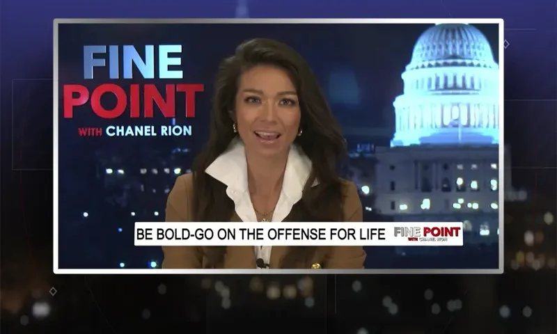 Video still of the host of Fine Point at the desk of their talk show on One America News Network.