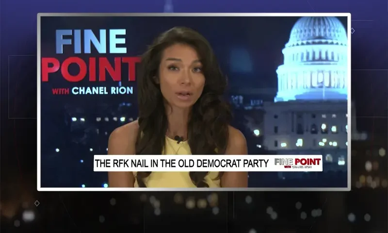 Video still of the host of Fine Point at the desk of their talk show on One America News Network.