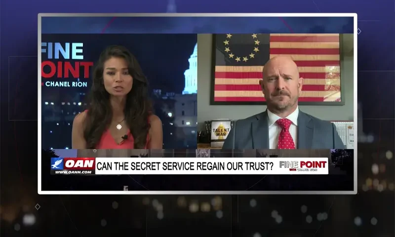 Video still from Fine Point on One America News Network showing a split screen of the host on the left side, and on the right side is the guest, Mike Sarraille.