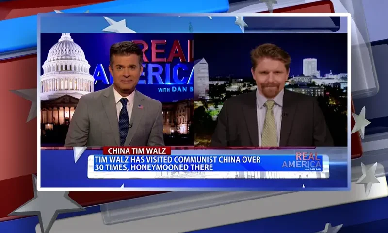 Video still from Real America on One America News Network showing a split screen of the host on the left side, and on the right side is the guest, Seamus Bruner.