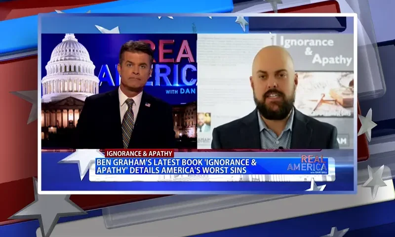 Video still from Real America on One America News Network showing a split screen of the host on the left side, and on the right side is the guest, Ben Graham.