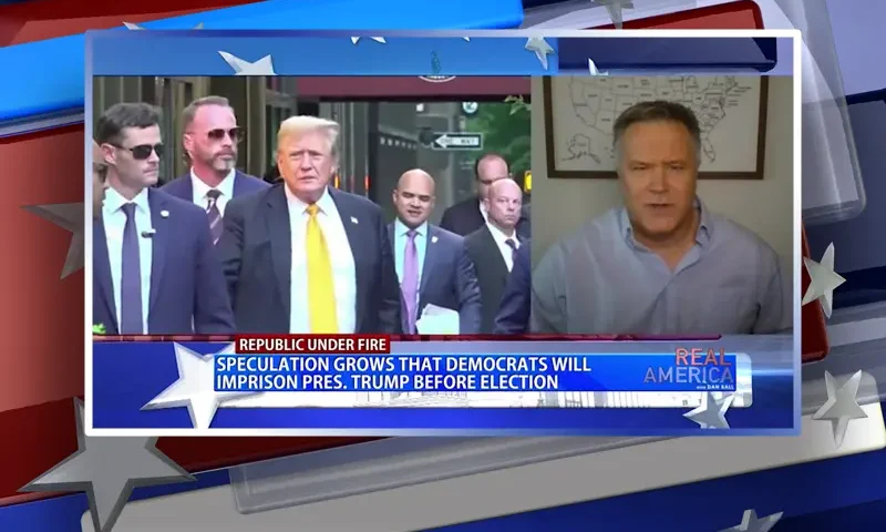Video still from Real America on One America News Network during an interview with the guest, John Pierce.