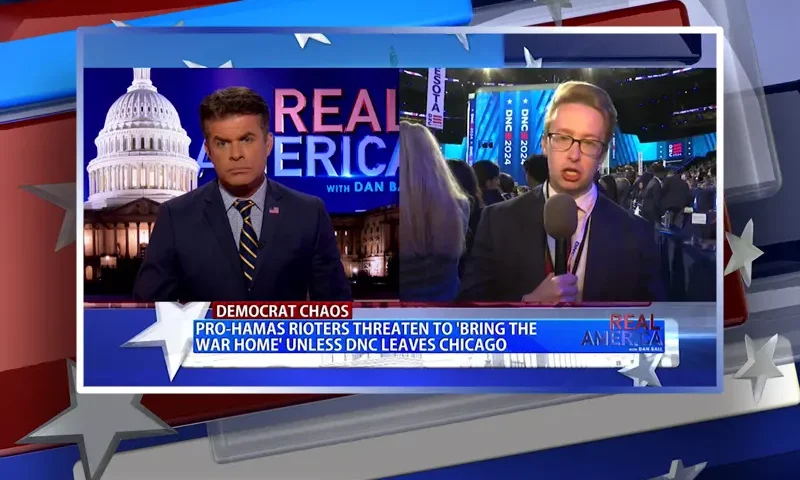 Video still from Real America on One America News Network showing a split screen of the host on the left side, and on the right side is the guest, Daniel Baldwin.