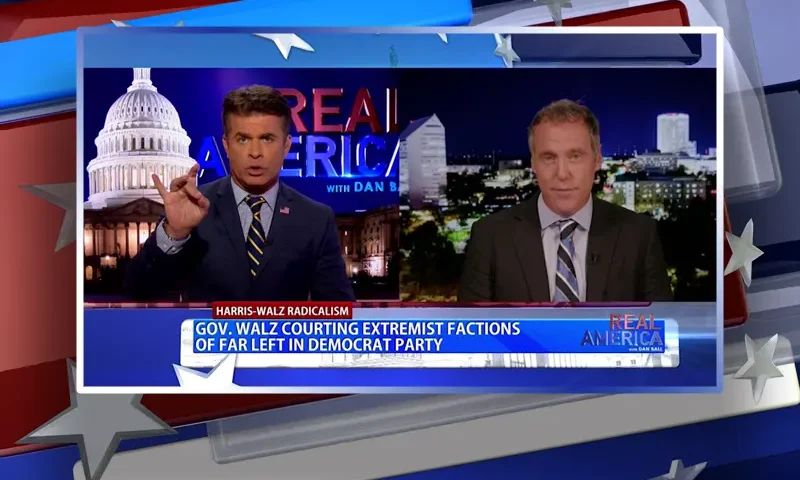 Video still from Real America on One America News Network showing a split screen of the host on the left side, and on the right side is the guest, Eric Eggers.