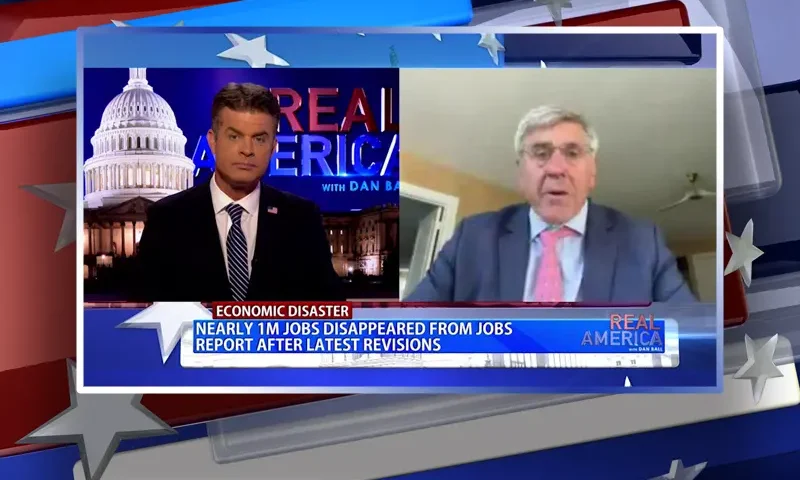 Video still from Real America on One America News Network showing a split screen of the host on the left side, and on the right side is the guest, Stephen Moore.