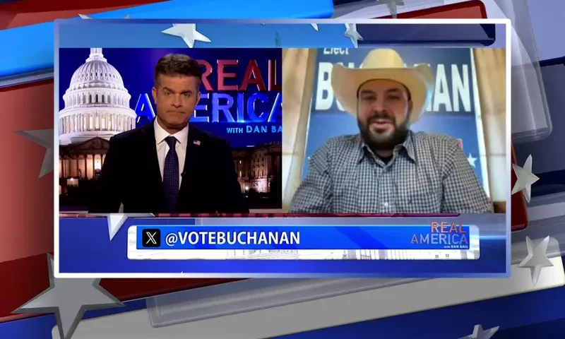 Video still from Real America on One America News Network showing a split screen of the host on the left side, and on the right side is the guest, Nathan Buchanan.