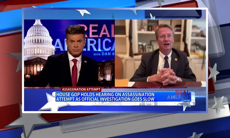 Video still from Real America on One America News Network showing a split screen of the host on the left side, and on the right side is the guest, Tim Burchett.