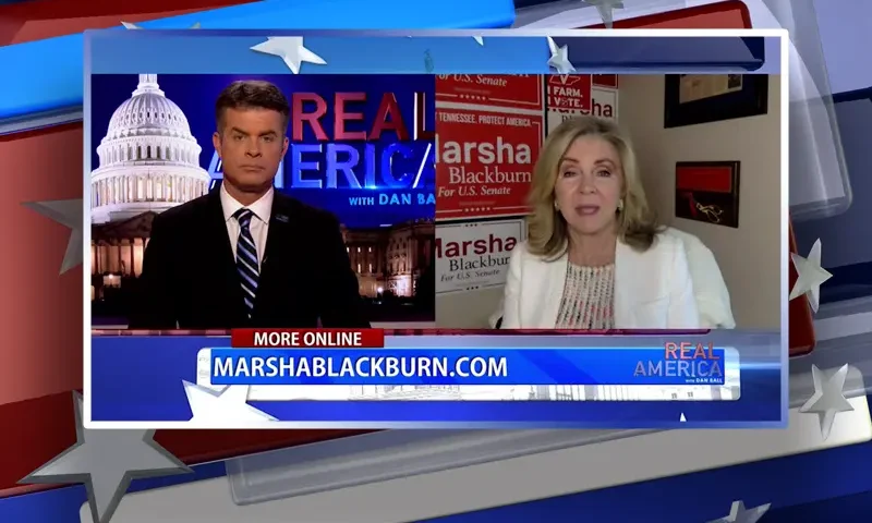 Video still from Real America on One America News Network showing a split screen of the host on the left side, and on the right side is the guest, Senator Marsha Blackburn.