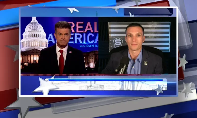 Video still from Real America on One America News Network showing a split screen of the host on the left side, and on the right side is the guest, Steve Friend.