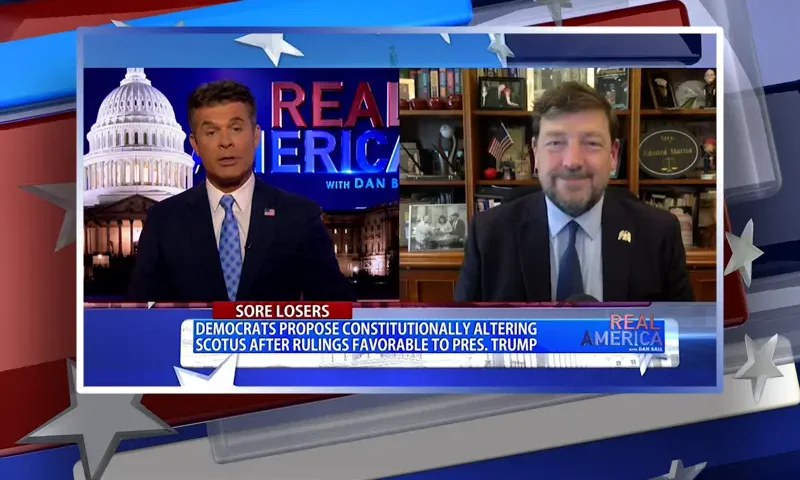 Video still from Real America on One America News Network showing a split screen of the host on the left side, and on the right side is the guest, Ed Martin.