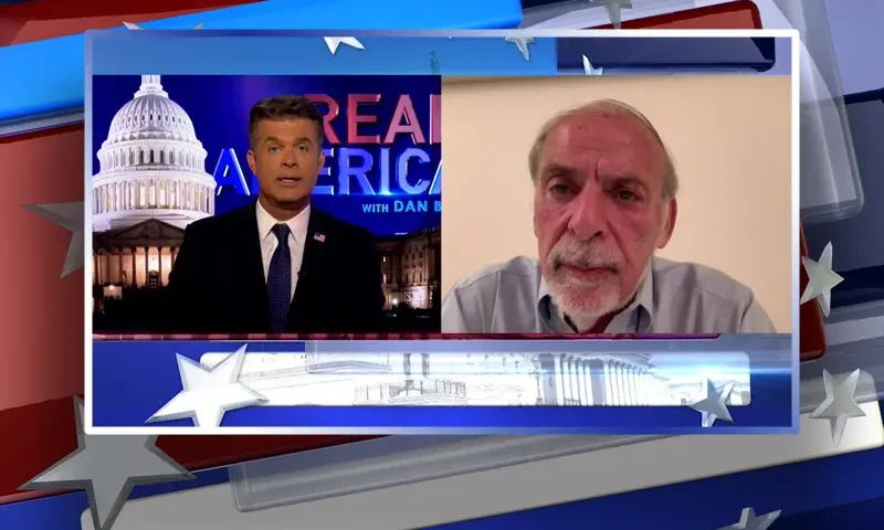 Video still from Real America on One America News Network showing a split screen of the host on the left side, and on the right side is the guest, Dov Hikind.
