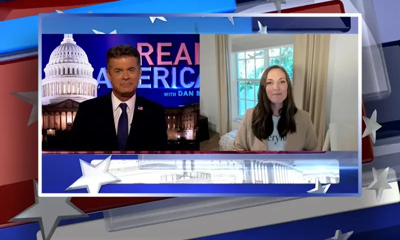 Video still from Real America on One America News Network showing a split screen of the host on the left side, and on the right side is the guest, Sarah Gabel Seifert.
