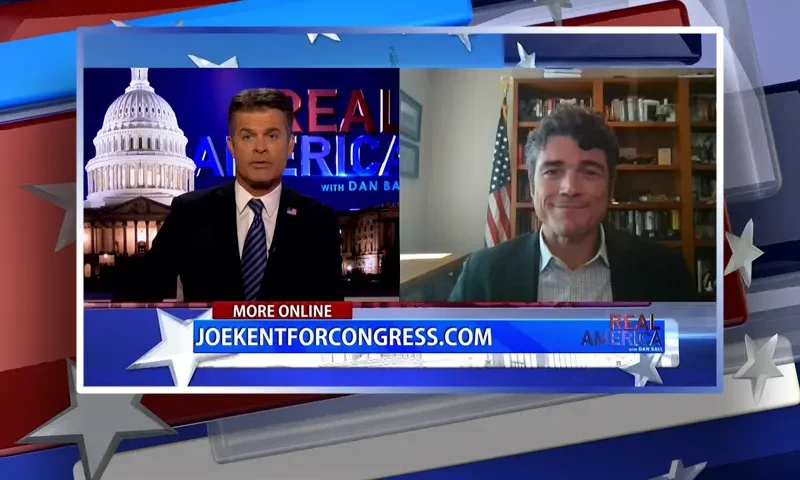Video still from Real America on One America News Network showing a split screen of the host on the left side, and on the right side is the guest, Joe Kent.
