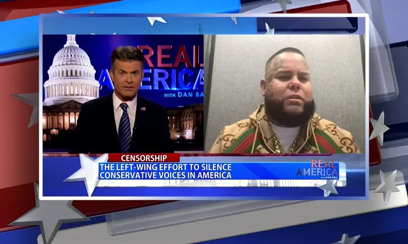 Video still from Real America on One America News Network showing a split screen of the host on the left side, and on the right side is the guest, Forgiato Blow.